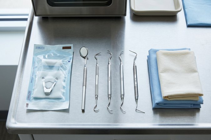 Sterilized dental instruments arranged on a brushed-steel countertop